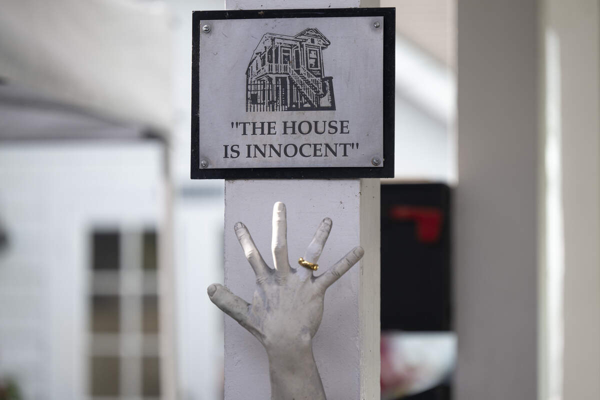 A sign that reads “the house is innocent” hangs outside the former home of serial killer Dorothea Puente in Sacramento on Sunday.